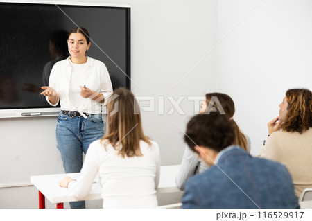 Young female teacher giving lecture to group of student 116529917