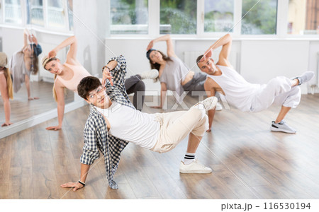 Young guy practicing breakdance in training hall 116530194