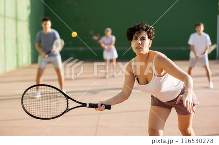 Woman serving ball during frontenis game outdoors 116530278