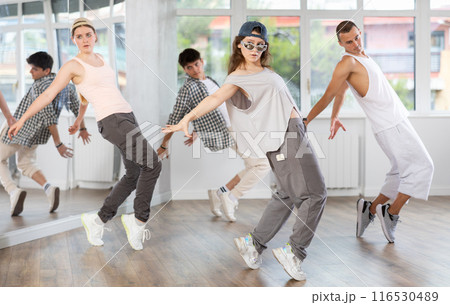 Young girl practicing hip hop slide moves in training hall 116530489