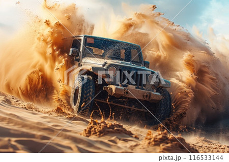 Off-road vehicle in the middle of a desert dune, with sand dramatically billowing around it 116533144