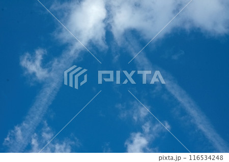 Beautiful clouds with contrails in the clear blue sky. Beautiful clouds with contrails in the clear blue sky. 116534248