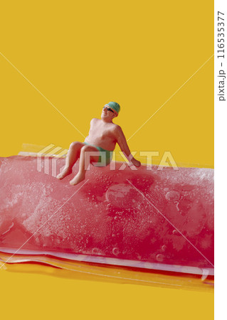 miniature man sitting on a freeze pop 116535377