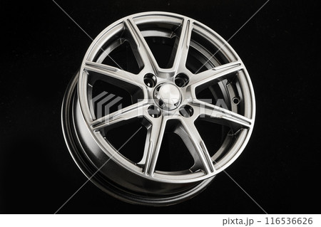 Modern lightweight die-cast aluminum wheel in gray color for a close-up car on a black background Modern lightweight die-cast aluminum wheel in gray color for a close-up car on a black background 116536626