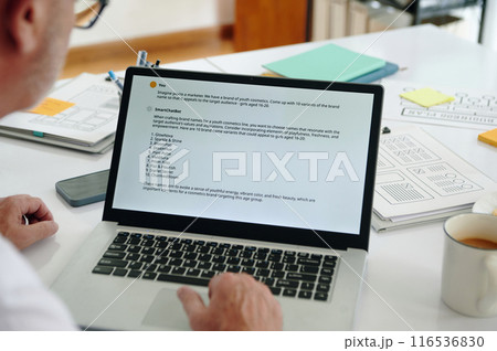 Marketer Examining Data On Laptop 116536830