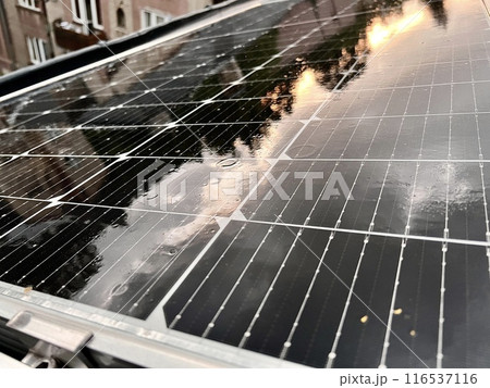 Solar panels installed on the roof of a house in the city in the rain. 116537116