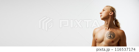 Banner. Bare chested, young man posing looking away against white studio background with negative space to insert your text. 116537174