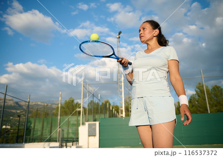 Woman plays tennis on the court 116537372