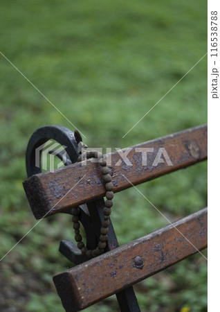 Forgotten rosaries on a park bench 116538788