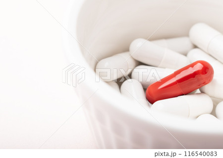 Pills closeup. Medical pills and capsules. Red capsule on white background. An allergy pill, antibiotics, supplements. Medicine, healthcare concept. Virus(viral), flu diseases. High quality photo Pills closeup. Medical pills and capsules. Red capsule on white background. An allergy pill, antibiotics, supplements. Medicine, healthcare concept. Virus(viral), flu diseases. High quality photo 116540083