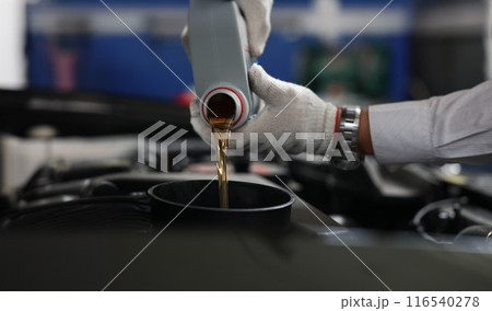 Auto mechanic refueling and pouring oil into engine motor ia car Auto mechanic refueling and pouring oil into engine motor ia car 116540278