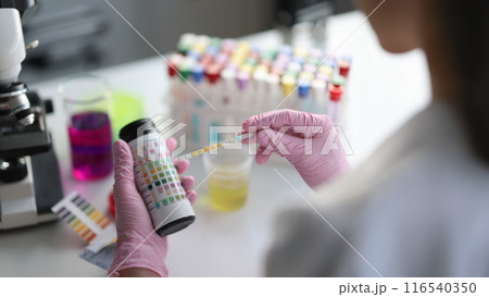 Laboratory assistant making medical test using testing strip 116540350