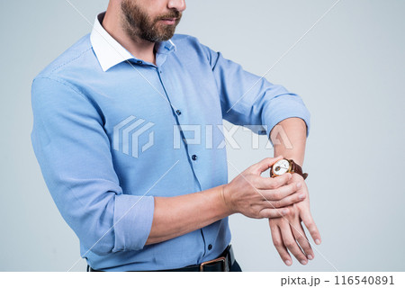 Bearded man cropped view look at wrist watch dial, time check Bearded man cropped view look at wrist watch dial, time check 116540891