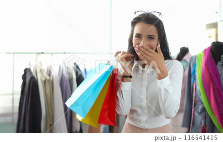 Happy smiling woman holding packages with purchases 116541415