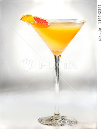 Grapefruit Glamour Bright yellow cocktail in a coupe glass garnished with a slice of grapefruit 116542341