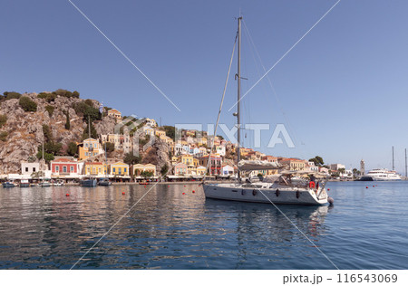 Bright multi-colored facades of houses on the shore of the bay in the village Symi Bright multi-colored facades of houses on the shore of the bay in the village Symi 116543069