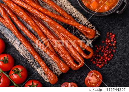 Mini sausages or cabanosi smoked with salt and spices Mini sausages or cabanosi smoked with salt and spices 116544295