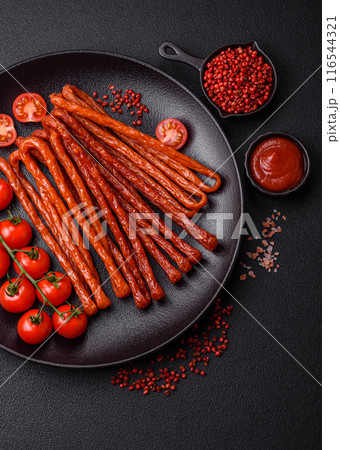 Mini sausages or cabanosi smoked with salt and spices Mini sausages or cabanosi smoked with salt and spices 116544321