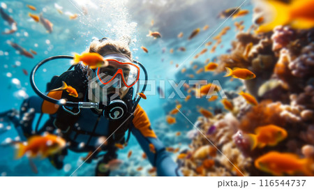 Smiling Scuba Diver Surrounded by Colorful Fish in Tropical Waters 116544737