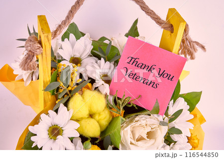November 11. Thank You Veterans written on a sticker in a bouquet of flowers, close-up 116544850