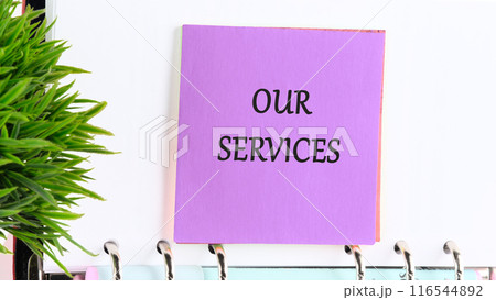 Business concept, copy space. OUR SERVICES word on a purple sticker on the background of a blank sheet of a business book Business concept, copy space. OUR SERVICES word on a purple sticker on the background of a blank sheet of a business book 116544892