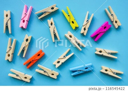 Wooden and colored clothespins as a symbol of inclusiveness in society. 116545422