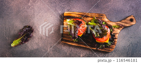 Juicy keto burgers on fresh lettuce leaves of cutlet, tomato and cheese top view web banner Juicy keto burgers on fresh lettuce leaves of cutlet, tomato and cheese top view web banner 116546181
