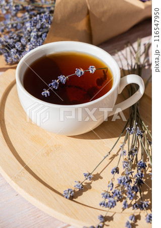Lavender flowers with herbal cup of tea. Concept of Herbal medicine natural remedy. Organic relieving stress. Healthy beverage fresh delicious floral hot tea. Antispasmodic effect naturopathy Lavender flowers with herbal cup of tea. Concept of Herbal medicine natural remedy. Organic relieving stress. Healthy beverage fresh delicious floral hot tea. Antispasmodic effect naturopathy 116547950