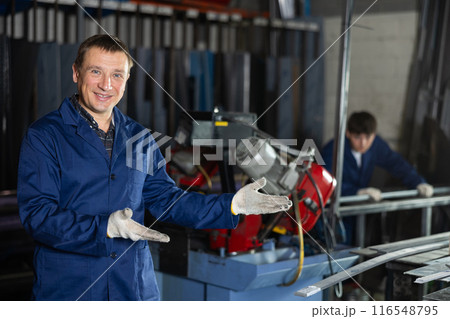 Portrait of male experienced engineer in a robe in workshop of metallurgical plant Portrait of male experienced engineer in a robe in workshop of metallurgical plant 116548795