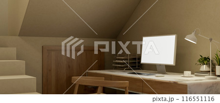 A cozy home workspace under the staircase, a computer mockup and decorative objects on a table. 116551116