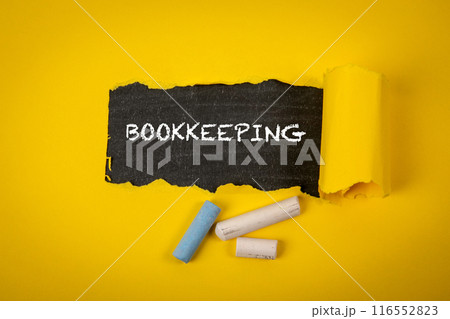 Bookkeeping . Text under torn yellow paper on a blackboard Bookkeeping . Text under torn yellow paper on a blackboard 116552823