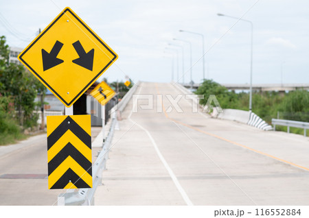 Selective focus of Lane Guidance Signal and Left curve warning sign.Background is concrete road. Selective focus of Lane Guidance Signal and Left curve warning sign.Background is concrete road. 116552884