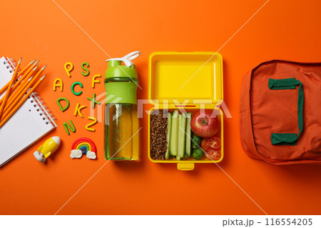 Yellow lunch box with delicious food and school supplies 116554205