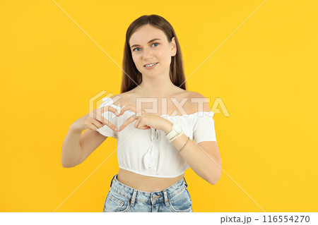 Attractive young girl shows heart with hands Attractive young girl shows heart with hands 116554270