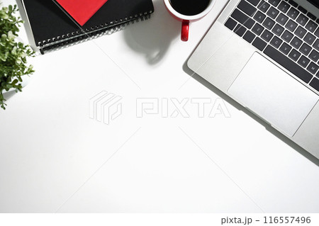 White office desk with a cup of coffee, laptop and notebook. Top view with copy space White office desk with a cup of coffee, laptop and notebook. Top view with copy space 116557496