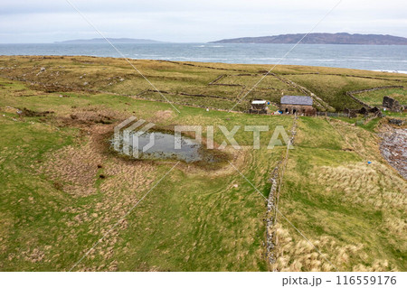 Aerial view of the Inishkeel island during a misty and hazy winter day - Portnoo, County Donegal, Ireland 116559176