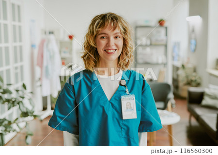 Portrait of blonde nurse looking at camera directly and smiling widely showing her teeth 116560300