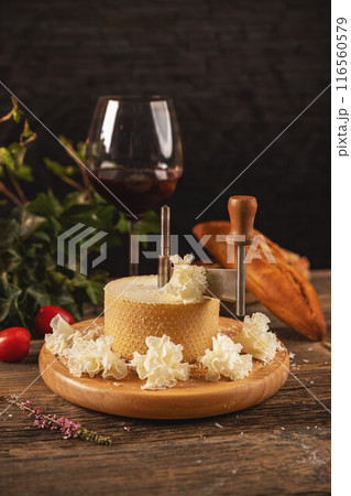 Slicing cheese on wooden board 116560579