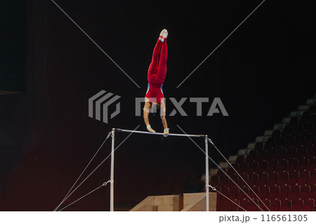 gymnast exercise horizontal bar in championship gymnastics, element long hang swings gymnast exercise horizontal bar in championship gymnastics, element long hang swings 116561305
