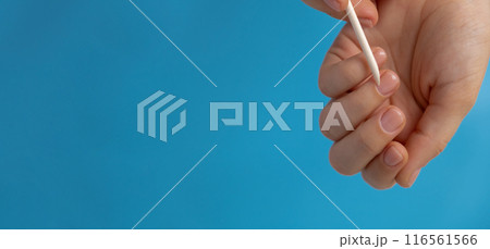 Pastel softness manicured nails on blue background. Mock up template copy space Woman showing her new manicure in colors of pastel palette. Simplicity decor fresh spring vibes earth-colored neutral 116561566