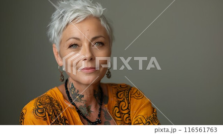 Portrait of a smiling senior adult woman with gray hair, looking at the camera, exuding confidence and beauty 116561763