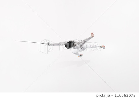 Fencer in white uniform and mask, captured from above in dramatic jump with their rapier against white studio background. Fencer in white uniform and mask, captured from above in dramatic jump with their rapier against white studio background. 116562078