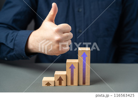 A man shows a thumbs up from a success graph. Successful investments. Income and economic development. Optimistic forecast. Entrepreneurship. A man shows a thumbs up from a success graph. Successful investments. Income and economic development. Optimistic forecast. Entrepreneurship. 116563425
