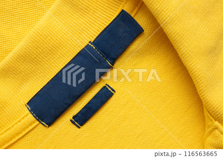 Blank blue laundry care clothes label on yellow shirt fabric texture background 116563665