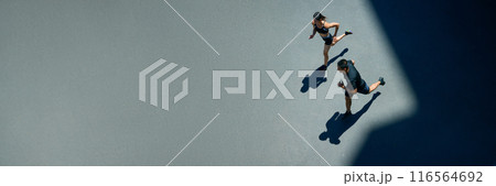 Banner. Aerial view of young people jogging together outdoor on sunny summer day at park. Negative space to insert your text. 116564692
