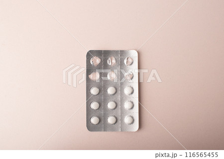 Pills, blister pack close up isolated on pink background. Medicine dose. Medicinal treatment, vitamins, supplements, contraceptive pills. Womens health. Copy space, banner. High quality photo Pills, blister pack close up isolated on pink background. Medicine dose. Medicinal treatment, vitamins, supplements, contraceptive pills. Womens health. Copy space, banner. High quality photo 116565455