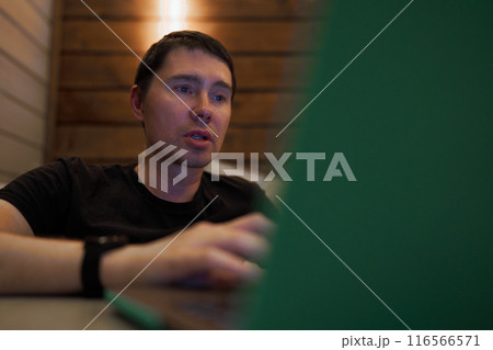 Man Engaged in Late-Night Work on Laptop Man Engaged in Late-Night Work on Laptop 116566571