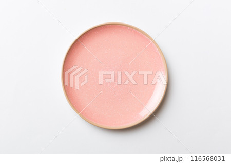 Top view of isolated of colored background empty round pink plate for food. Empty dish with space for your design 116568031