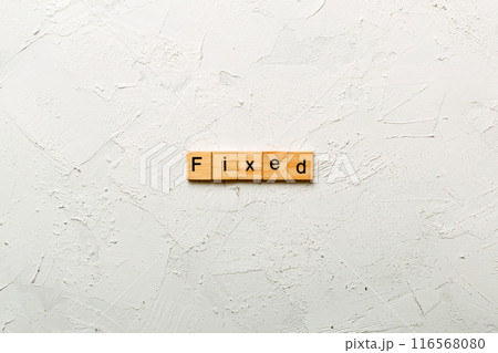 fixed word written on wood block. fixed text on table, concept fixed word written on wood block. fixed text on table, concept 116568080