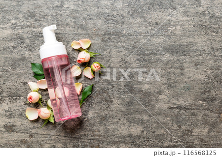 Fancy healthcare bottles for serum, micellar, tonic, toner, lotion, water and cream with rose flower. Natural oranic spa cosmetics concept. Mockup, template, Top view 116568125